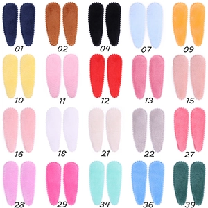 Flat lay of 20 colors candy-colored plush snap hair clips with wavy edge for girls
