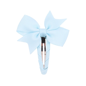 Close-up of light blue grosgrain ribbon bow hair clip with fabric-wrapped metal base