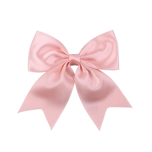 Detail of light pink satin bow hair clip with smooth silk texture and elegant finish