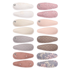 Detailed set of 8 floral embroidery snap hair clips with diverse patterns and soft colors