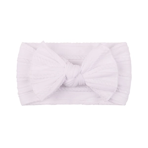 Close-up of soft ribbed nylon headband for babies featuring a large white bow