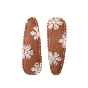 Detail of caramel brown floral BB clips with white daisy embroidery and scalloped edges