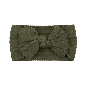 Close-up of olive green cable knit baby headband with a large decorative bow