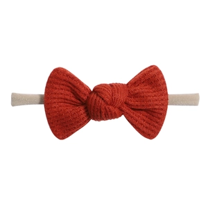 Detail view of the red waffle texture knit bow and high-elastic band for baby girls