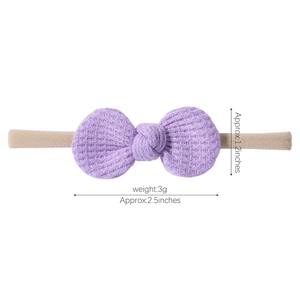 Baby waffle knit headband with purple knotted bow on stretch nylon hair band