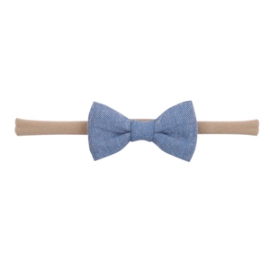 Detail of baby headband featuring a blue textured bow on khaki elastic nylon band