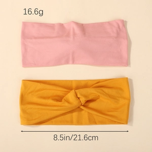 Cross-knot elastic headbands in pink and yellow, measuring 8.5 inches wide
