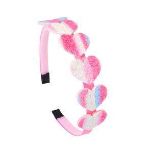 Detail of pink children's headband featuring gradient glitter hearts and smooth finish