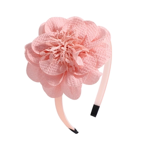 Close-up of pink large chiffon flower headband with delicate layered fabric petals