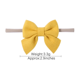 Yellow bow headband for infants made of soft fabric with grey elastic nylon band