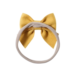 Soft nylon baby headband with a large mustard yellow bow and grey elastic strap