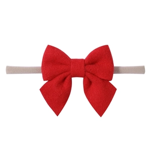 Soft nylon baby headband featuring a large bright red bow for infants and toddlers