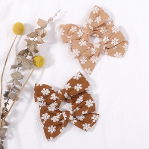 Floral embroidered bow hair clips in tan and brown fabric for girls and women