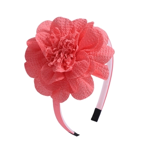 Close-up of pink chiffon flower headband with layered petals and soft fabric texture