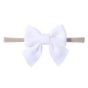 Close-up of white soft fabric bow attached to a high-elastic nude nylon baby headband