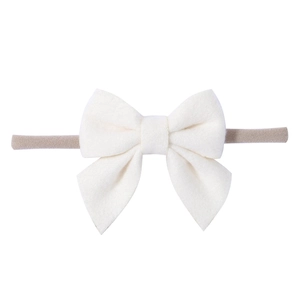 Detail of soft white bow hairband for infants with high-elastic nylon band