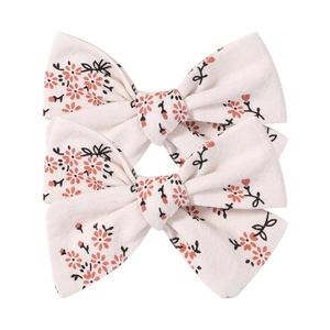 Close-up of floral embroidery on off-white cotton linen bow hair clips set for women