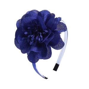 Detailed close-up of a large navy blue chiffon flower headband with delicate stamen texture