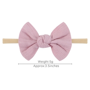Pink velvet bow baby nylon headband with 3.5-inch fabric knot on white background