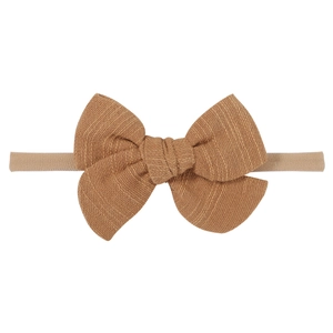 Detail of baby headband with ginger knit bow and soft high-elastic nylon band