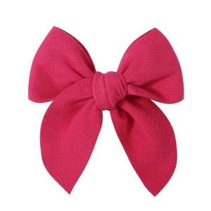 Detailed view of the fuchsia satin fabric texture on the large 5.1 inch hair bow clip