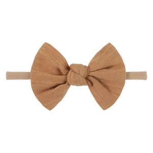 Detailed view of camel velvet bow on soft nylon baby headband with delicate texture