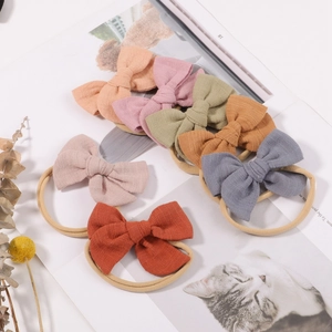 7-piece set of handmade nylon headbands with linen fabric bows for babies and kids