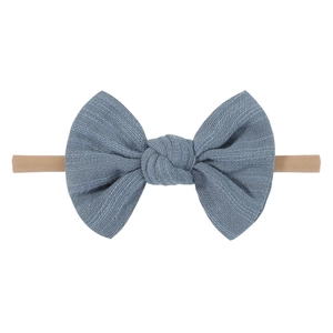 Detail of blue-grey Morandi cotton bow with elastic skin-friendly nylon headband for babies