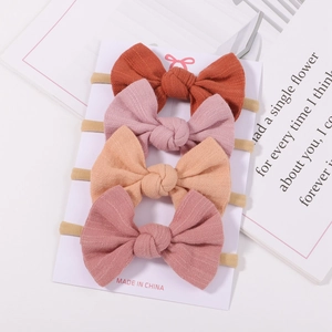 Set of four soft nylon baby headbands with velvet bow ties in earthy floral tones