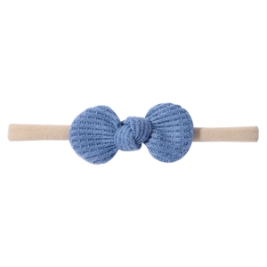 Close-up of blue waffle knit bow headband with highly elastic nylon band for infants