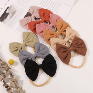 Set of 10 colorful nylon baby headbands with textured fabric bows for infants