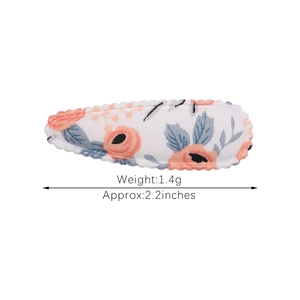 Floral fabric hair clip for women with orange flower embroidery and wavy stitched edges