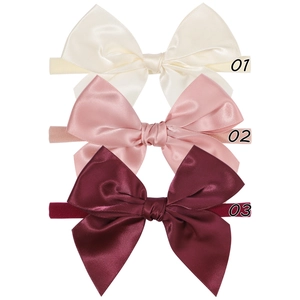 Three-piece set of satin bow baby headbands in ivory, rose pink, and deep burgundy nylon