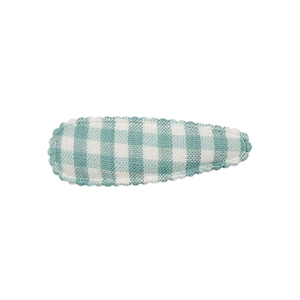 Detail of fabric BB hair clip with green and white gingham pattern and scalloped edges