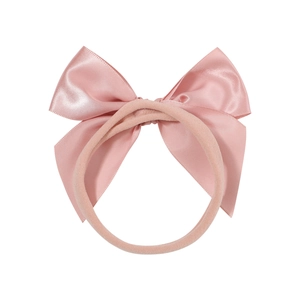 Pink satin bow nylon baby headband with elegant pearly luster on a white background