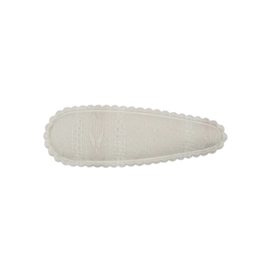 Close-up of beige fabric BB hair clip with scalloped edges and woven texture for girls