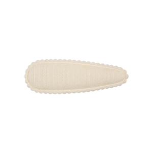 Detailed macro view of cream floral embroidery on cotton-linen teardrop snap hair clip