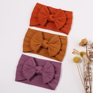 Three-piece baby nylon bow headband set in orange, ginger, and violet ribbed fabric