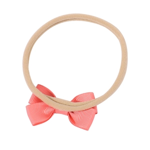 Baby girl nylon headband with coral orange grosgrain ribbon bow on a soft elastic band