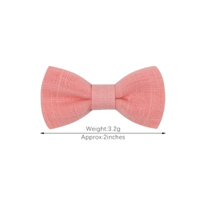 Pink fabric bow hair clip for children, soft textile texture, 2 inches wide and 3.2g weight