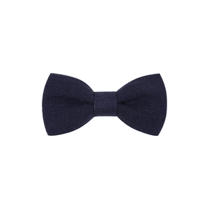 Detail of dark blue linen bow hair clip with rich fabric texture on white background