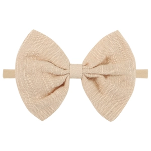 Close-up of beige linen bow headband for babies with high-elastic nylon strap detail