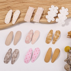 Detailed set of 18 fabric-covered children hair clips featuring lace and floral patterns