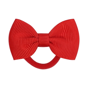 Detailed close-up of a vibrant red grosgrain ribbon bow on a matching elastic hair tie