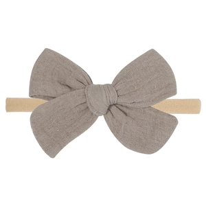 Close-up of soft cotton muslin bow headband with high-stretch seamless nylon band