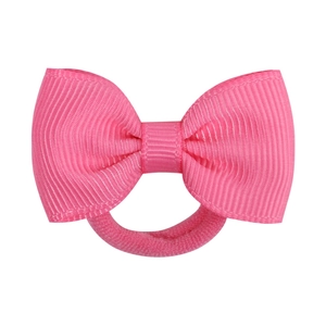 Detail of a bright pink ribbon bow hair tie made of ribbed fabric for girls and kids