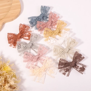 Set of 10 handmade lace bow hair clips for girls in various pastel and neutral colors