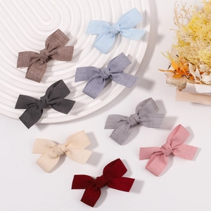 Detailed set of 8 fabric bow clips in Morandi colors with natural linen texture