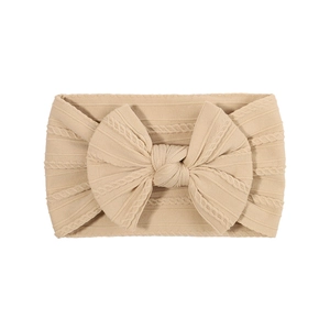 Bandeau élastique bébé avec grand nœud en tissu tricoté côtelé de couleur beige