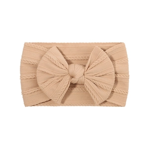 Bandeau bébé rose chair en jacquard élastique avec un grand nœud papillon doux et souple